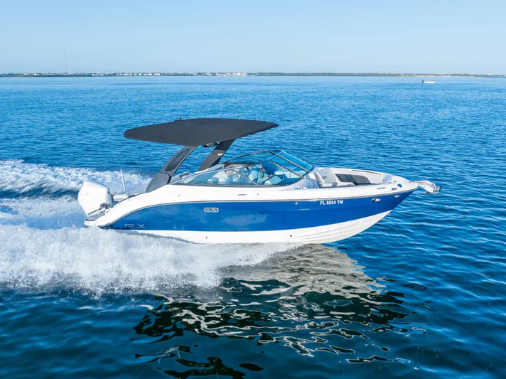  Yacht Photos Pics 2023 Sea Ray SLX 260 Outboard cruising on open water, featuring sleek blue and white design.