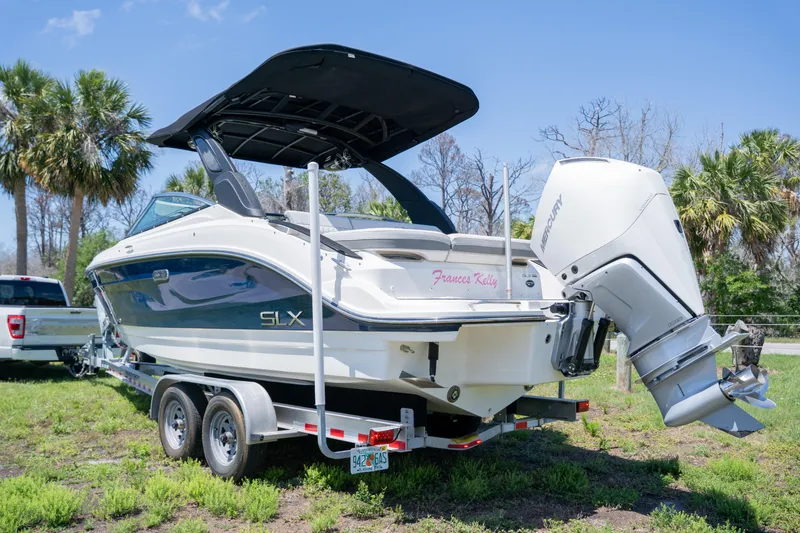  Yacht Photos Pics 2023 Sea Ray SLX 260 Outboard boat on trailer, parked outdoors with palm trees.