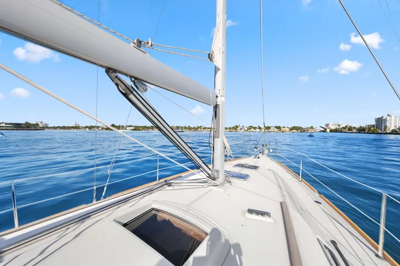 Americana Yacht Photos Pics Sailing on a 2014 Beneteau Oceanis 37 yacht in calm blue waters under a clear sky.