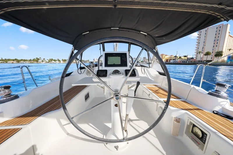 Americana Yacht Photos Pics Cockpit view of 2014 Beneteau Oceanis 37 sailboat with steering wheel and navigation system.