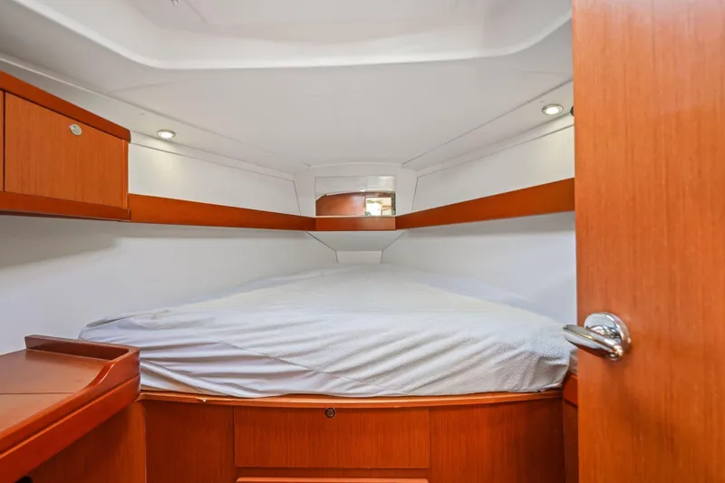 Americana Yacht Photos Pics 2014 Beneteau Oceanis 37 cabin interior with wooden finish and cozy bed.