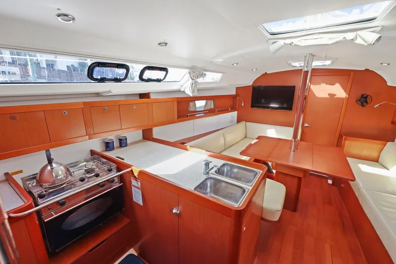 Americana Yacht Photos Pics Interior of 2014 Beneteau Oceanis 37 yacht with modern kitchen and seating area.