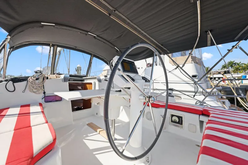 Americana Yacht Photos Pics Cockpit of 2014 Beneteau Oceanis 37 sailboat with striped seating and steering wheel.