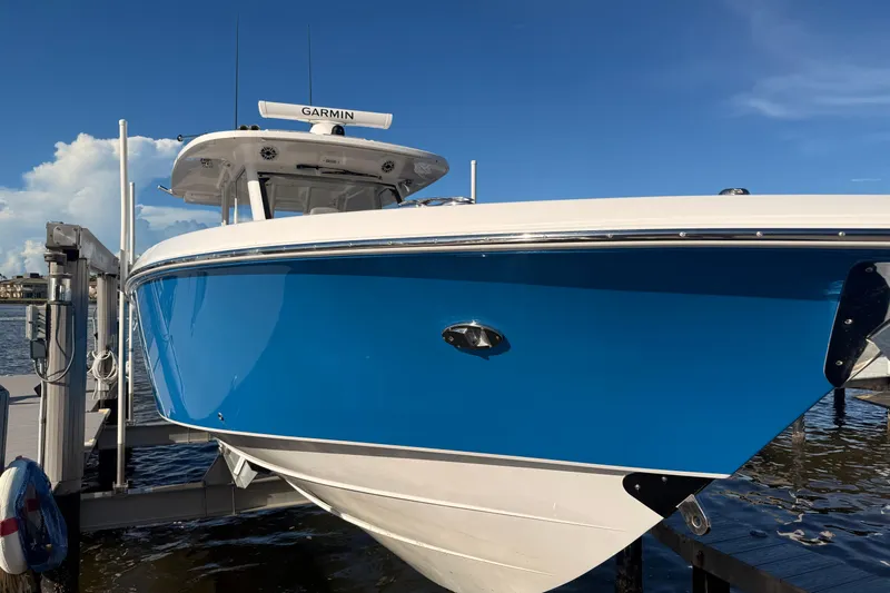  Yacht Photos Pics 2023 Everglades 395 Center Console boat docked, featuring a sleek blue hull.