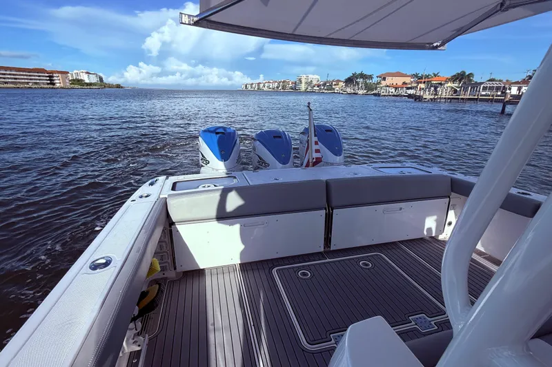 Yacht Photos Pics 2023 Everglades 395 Center Console boat on water, featuring dual engines and spacious deck.