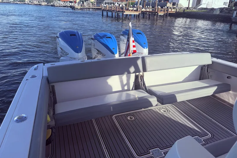  Yacht Photos Pics 2023 Everglades 395 Center Console boat with triple outboard engines and spacious seating.