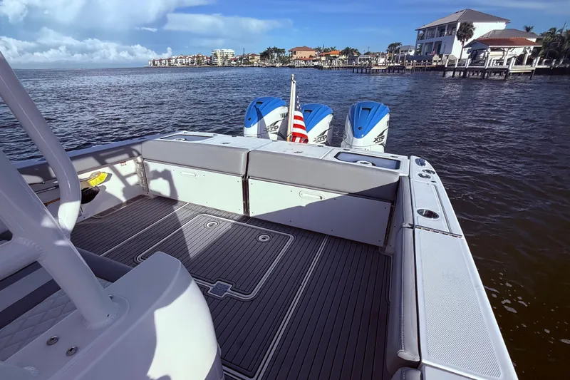  Yacht Photos Pics 2023 Everglades 395 Center Console boat on water, featuring spacious deck and powerful engines.