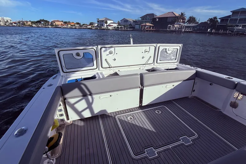  Yacht Photos Pics 2023 Everglades 395 Center Console boat with spacious deck and waterfront view.