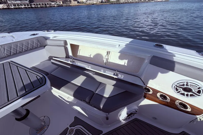  Yacht Photos Pics 2023 Everglades 395 Center Console boat interior with seating and storage, on calm water.