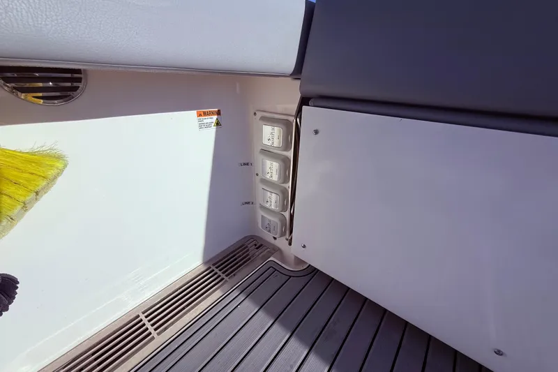  Yacht Photos Pics 2023 Everglades 395 Center Console boat interior with control panel and warning label.