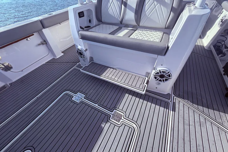  Yacht Photos Pics 2023 Everglades 395 Center Console boat interior with cushioned seating and sleek flooring design.