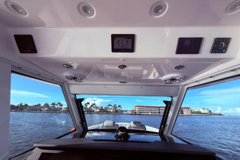  Yacht Photos Pics Interior view of 2023 Everglades 395 Center Console boat with waterfront scenery.