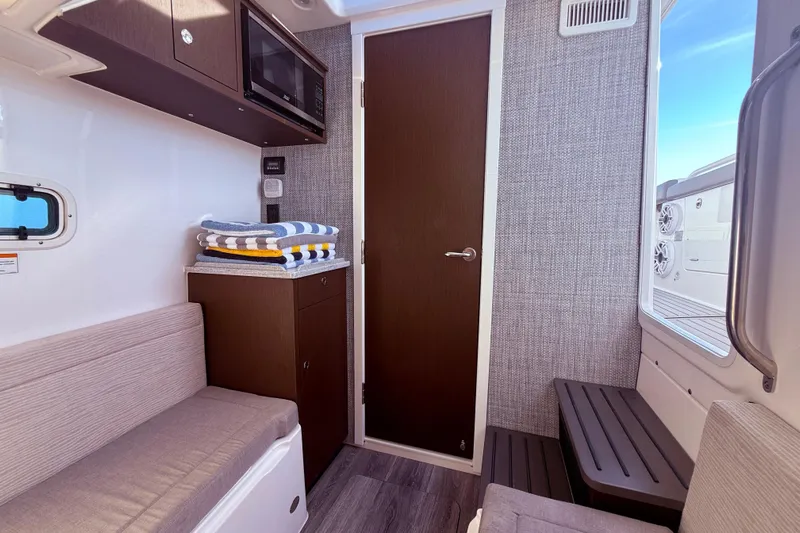  Yacht Photos Pics Interior of 2023 Everglades 395 Center Console boat with seating, storage, and window view.