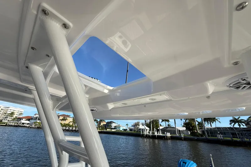  Yacht Photos Pics 2023 Everglades 395 Center Console boat roof with clear sky and waterfront view.
