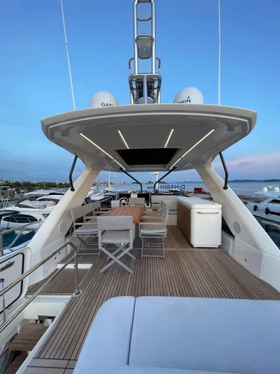 Bazinga Yacht Photos Pics Luxury 2023 Prestige 690 yacht deck with modern seating and ocean view.