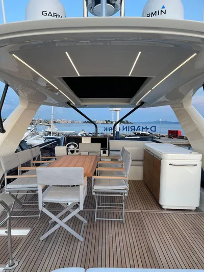 Bazinga Yacht Photos Pics Luxury 2023 Prestige 690 yacht deck with seating and dining area.