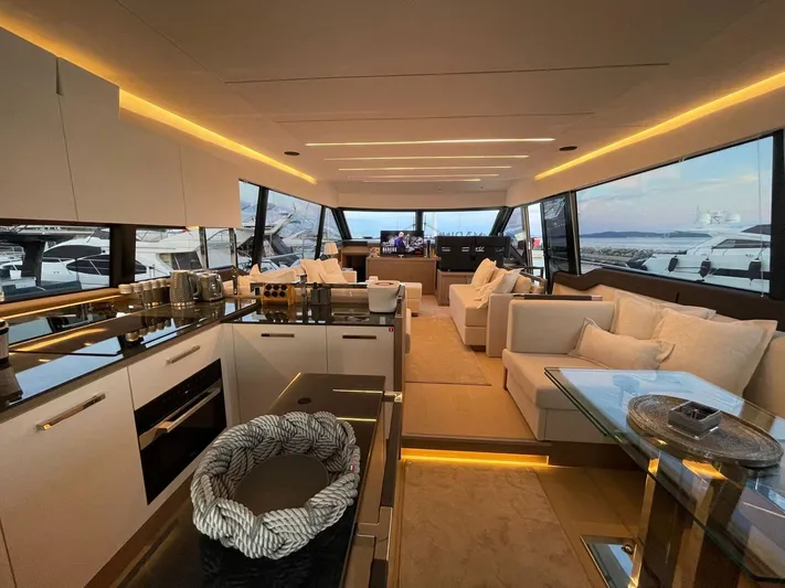 Bazinga Yacht Photos Pics Luxurious interior of 2023 Prestige 690 yacht with modern kitchen and spacious seating area.