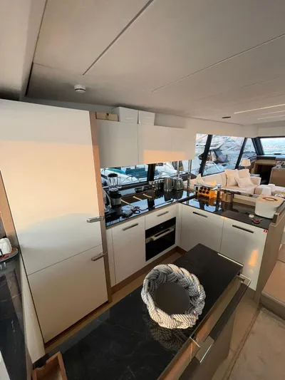 Bazinga Yacht Photos Pics Modern kitchen interior on a 2023 Prestige 690 yacht, featuring sleek cabinetry and appliances.