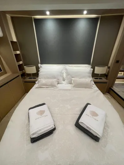 Bazinga Yacht Photos Pics Luxurious bedroom interior on 2023 Prestige 690 yacht with elegant bedding and ambient lighting.