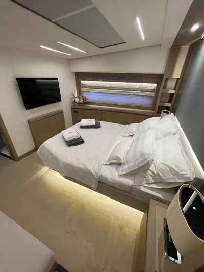 Bazinga Yacht Photos Pics Luxurious bedroom interior of 2023 Prestige 690 yacht with modern design and cozy ambiance.