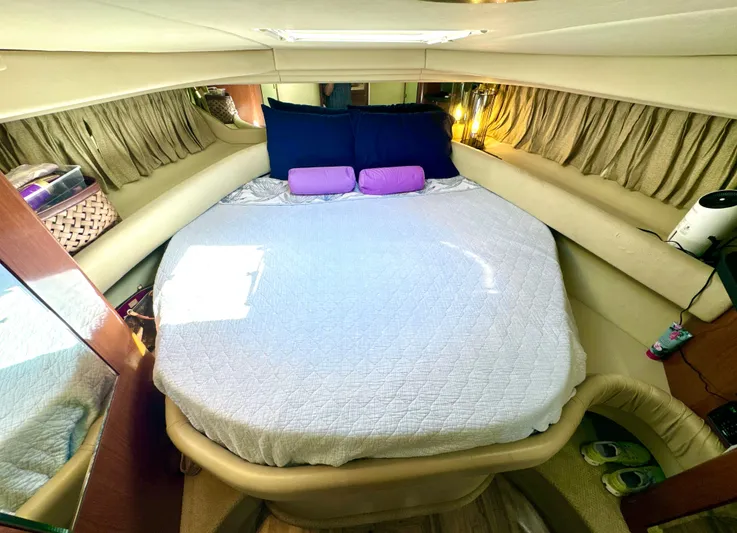 Seaswing Yacht Photos Pics 2002 Sea Ray 380 Sundancer cabin with a cozy bed and ambient lighting.