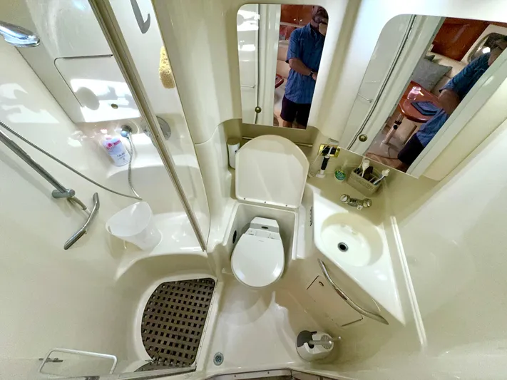 Seaswing Yacht Photos Pics 2002 Sea Ray 380 Sundancer bathroom with shower, toilet, sink, and mirror.