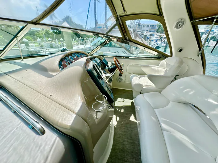 Seaswing Yacht Photos Pics Interior cockpit of a 2002 Sea Ray 380 Sundancer yacht with white leather seating.