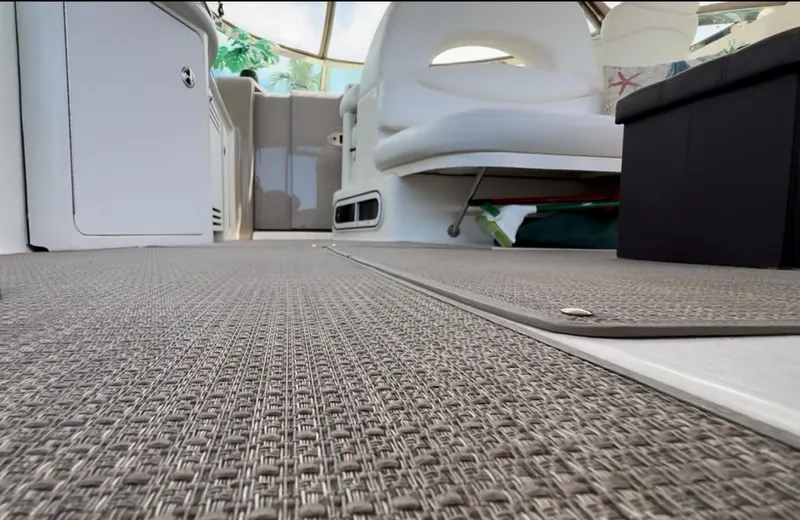 Seaswing Yacht Photos Pics Interior of 2002 Sea Ray 380 Sundancer with woven floor mat and white seating.