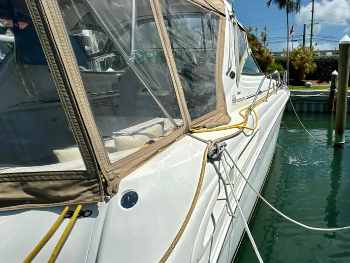 Seaswing Yacht Photos Pics 2002 Sea Ray 380 Sundancer docked, side view with clear canopy.