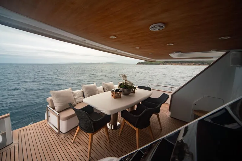  Yacht Photos Pics Luxurious Diano 24 yacht deck with elegant dining area, ocean view, and wooden finish, 2005 model.