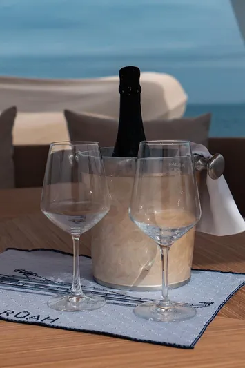  Yacht Photos Pics Two wine glasses and champagne on a yacht with ocean view, Diano 24, 2005.