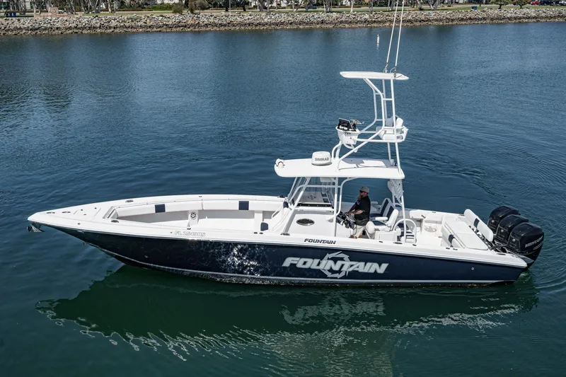Go Time Yacht Photos Pics 2019 Fountain 38 CC boat cruising on calm water, side view.