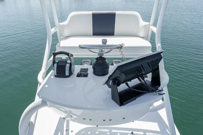 Go Time Yacht Photos Pics 2019 Fountain 38 CC boat helm with controls and display on calm water.