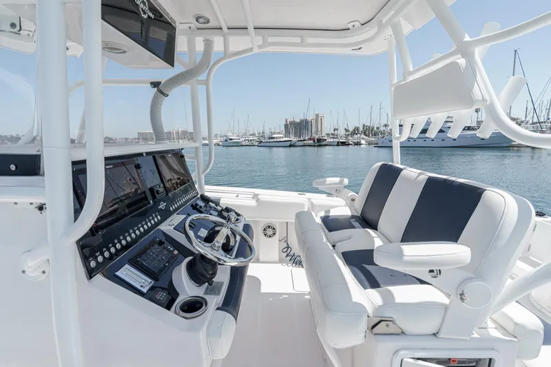 Go Time Yacht Photos Pics 2019 Fountain 38 CC boat interior with modern controls and seating, docked at a marina.