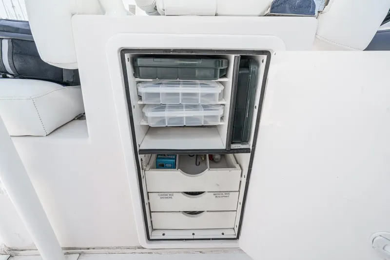 Go Time Yacht Photos Pics Storage compartment on a 2019 Fountain 38 CC boat with organized containers and drawers.