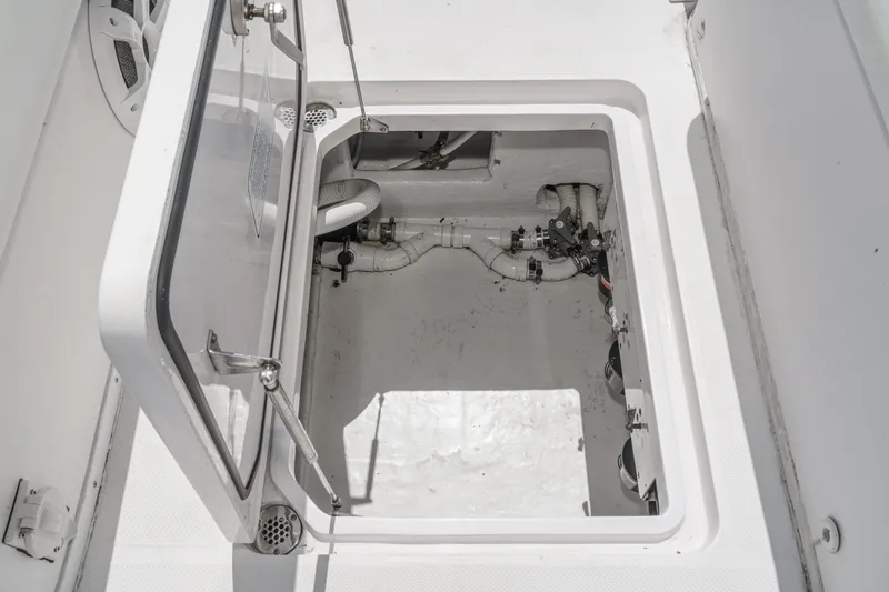 Go Time Yacht Photos Pics Open hatch of 2019 Fountain 38 CC boat showing interior components and piping.