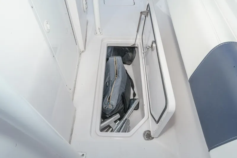 Go Time Yacht Photos Pics Open storage compartment on 2019 Fountain 38 CC boat, containing equipment and gear.