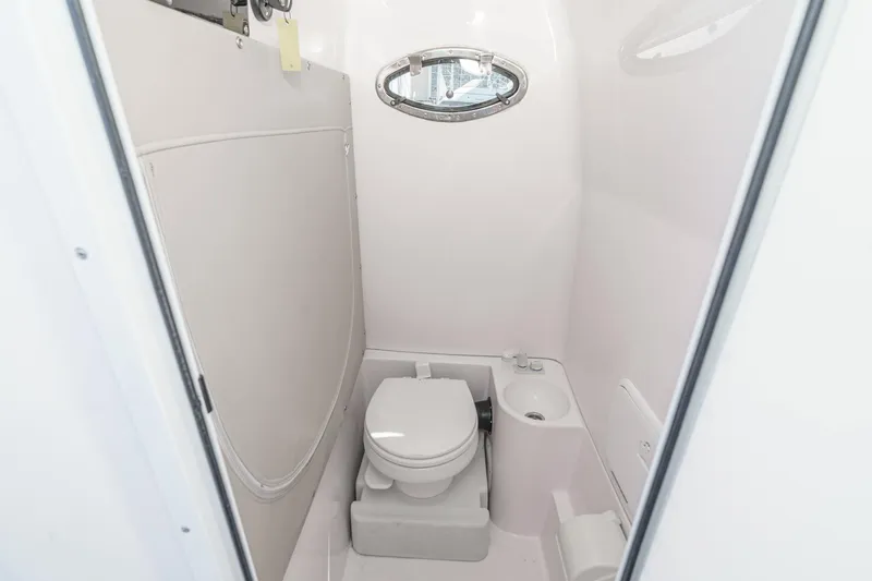 Go Time Yacht Photos Pics Compact bathroom in 2019 Fountain 38 CC boat with toilet and sink.