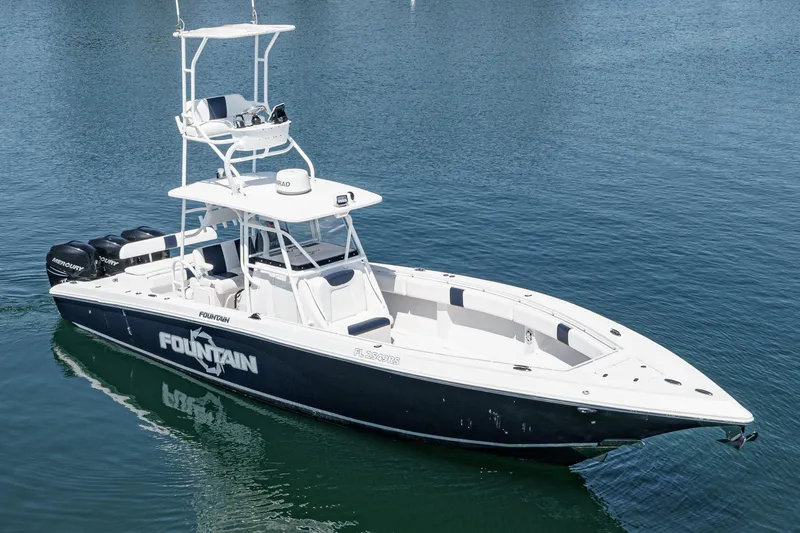 Go Time Yacht Photos Pics 2019 Fountain 38 CC boat on calm water, featuring sleek design and multiple outboard engines.