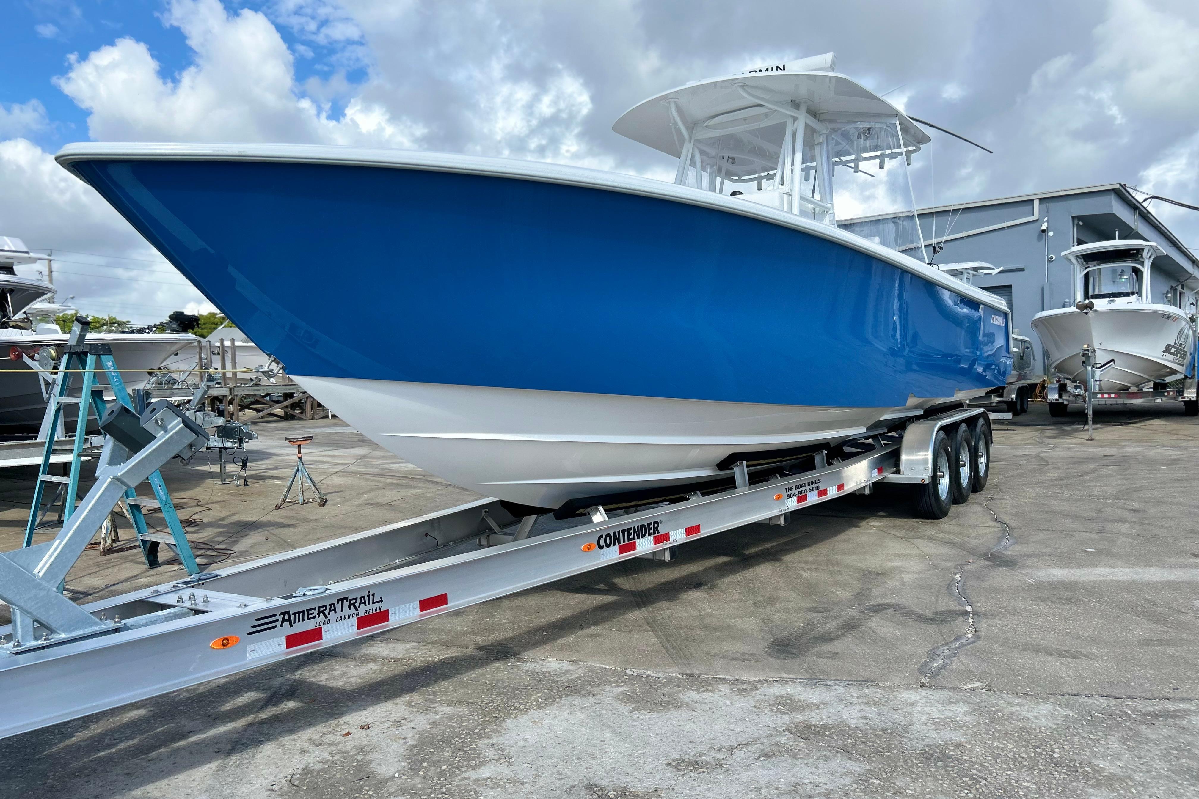 2025 Contender 35 ST boat on trailer, blue hull, parked outdoors.