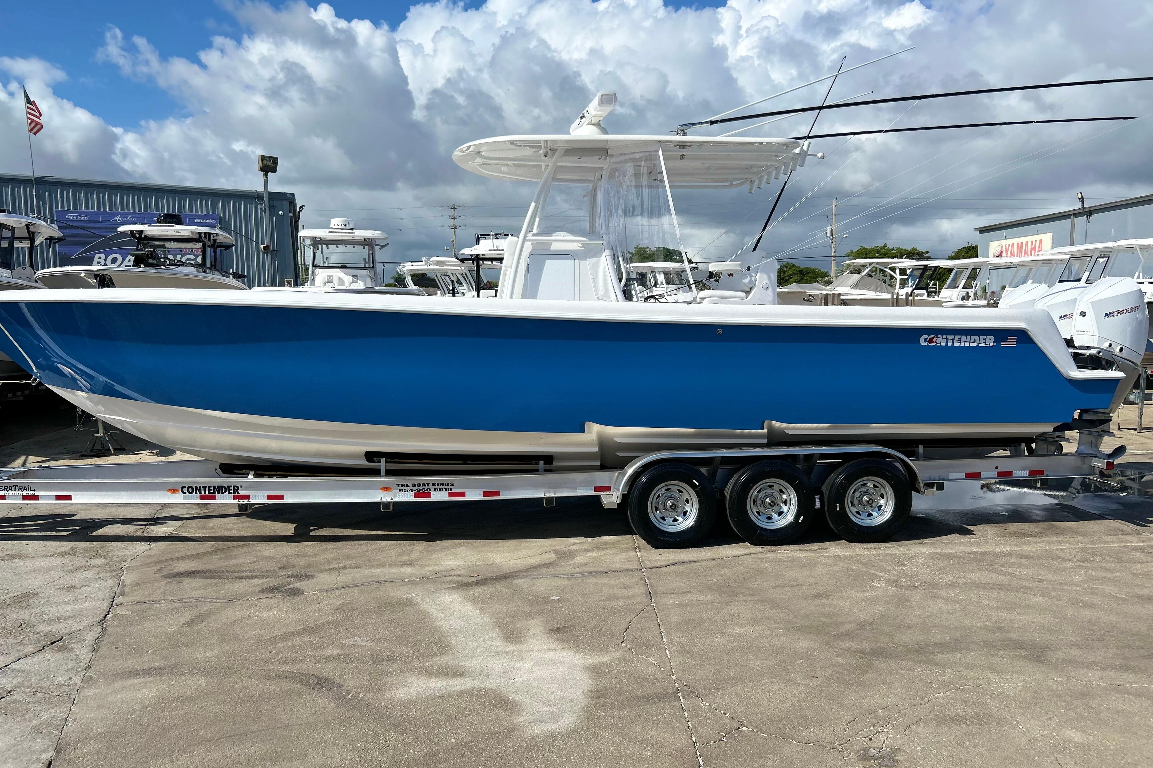2025 Contender 35 ST boat in blue on a trailer, displayed outdoors.