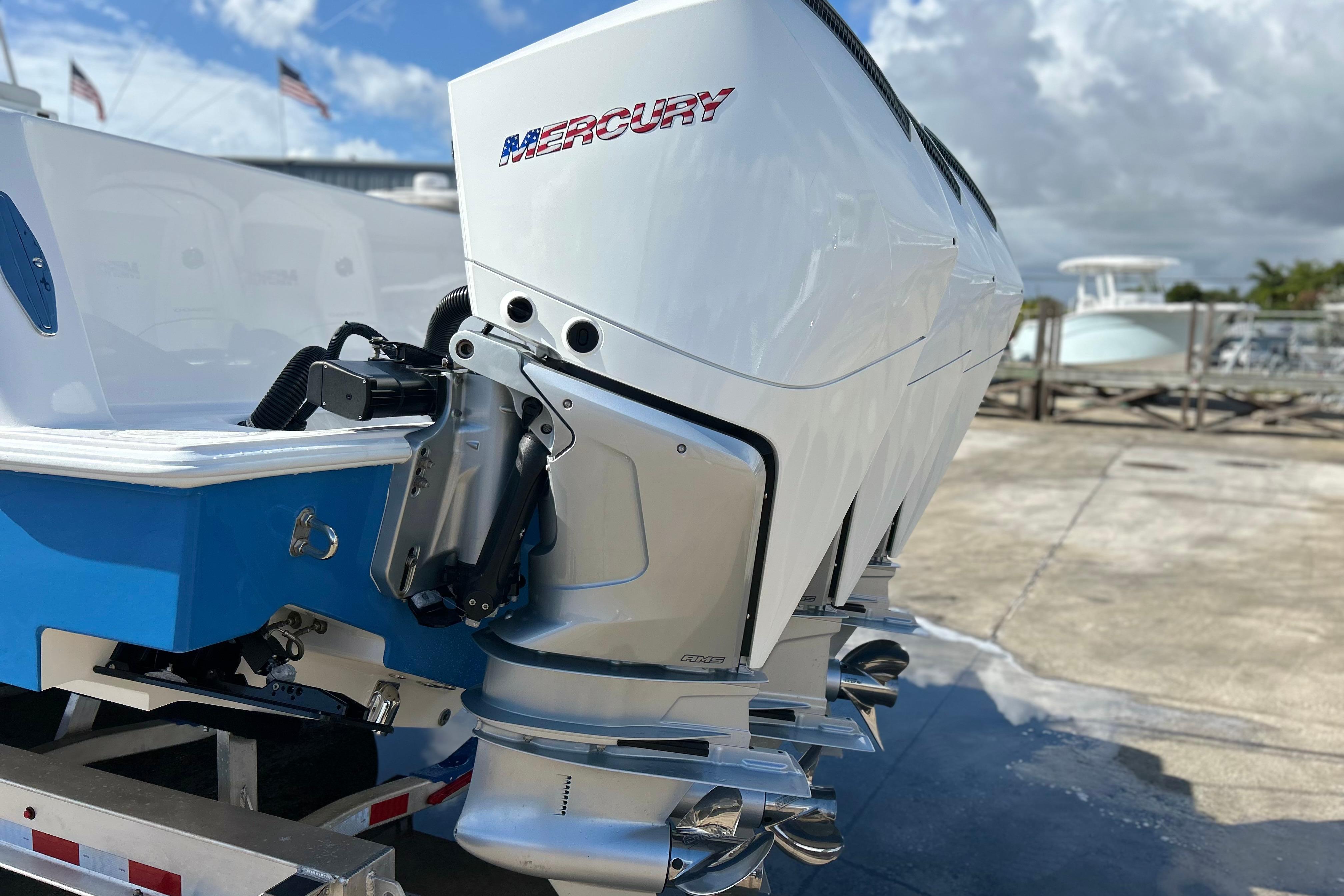 2025 Contender 35 ST boat with Mercury outboard engines, docked under a cloudy sky.