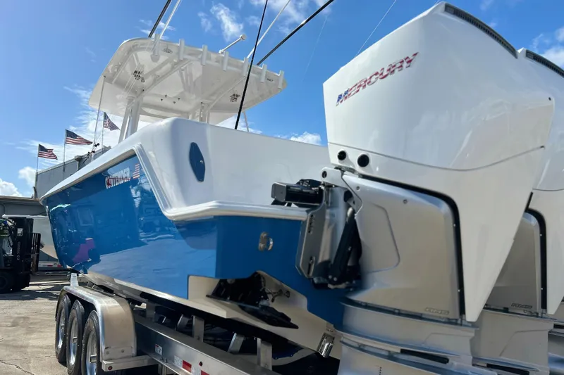  Yacht Photos Pics 2025 Contender 35 ST boat with Mercury engines on a trailer, under a clear blue sky.