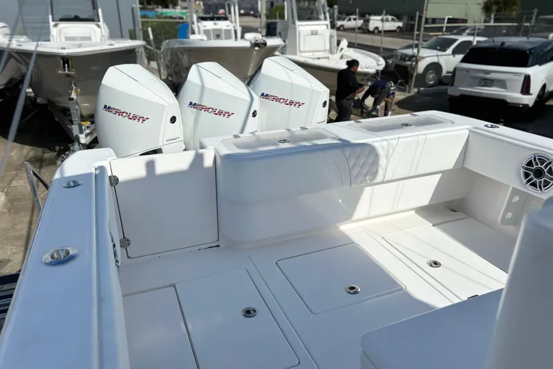  Yacht Photos Pics 2025 Contender 35 ST boat with triple Mercury engines, docked in a marina.