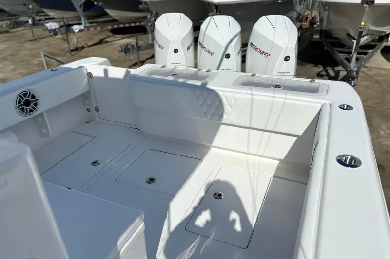  Yacht Photos Pics 2025 Contender 35 ST boat deck with Mercury Verado engines in a marina setting.