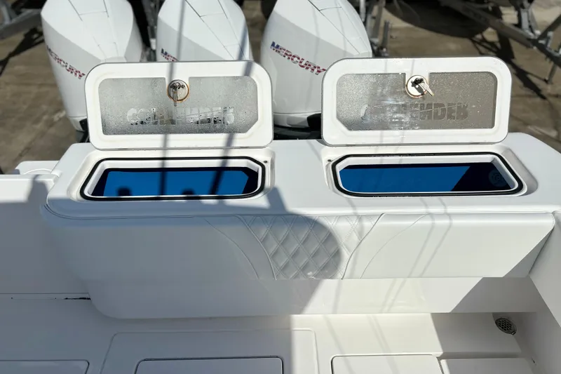  Yacht Photos Pics 2025 Contender 35 ST boat with open storage compartments and Mercury engines in the background.