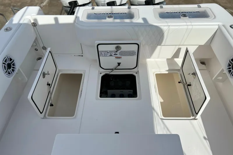  Yacht Photos Pics 2025 Contender 35 ST boat deck with open storage compartments and speakers.