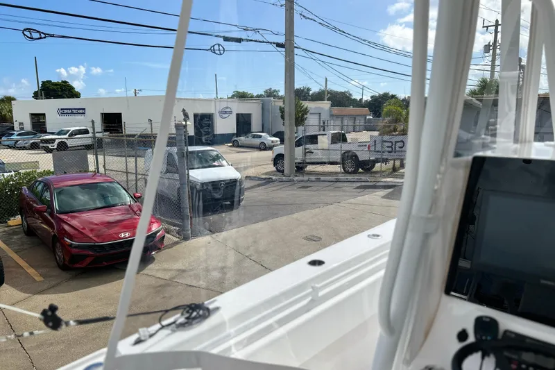  Yacht Photos Pics View from 2025 Contender 35 ST boat, overlooking parked cars and a service center.