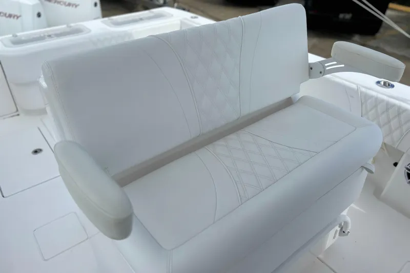  Yacht Photos Pics White cushioned seating on 2025 Contender 35 ST boat, featuring diamond stitching and armrests.