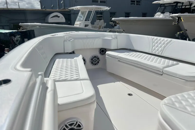 Yacht Photos Pics 2025 Contender 35 ST boat interior with white cushioned seating and speakers.